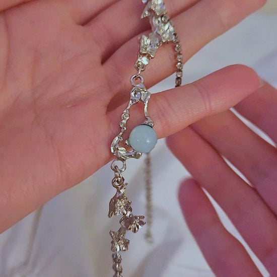 Video of ocean necklace being held and shown off in hands