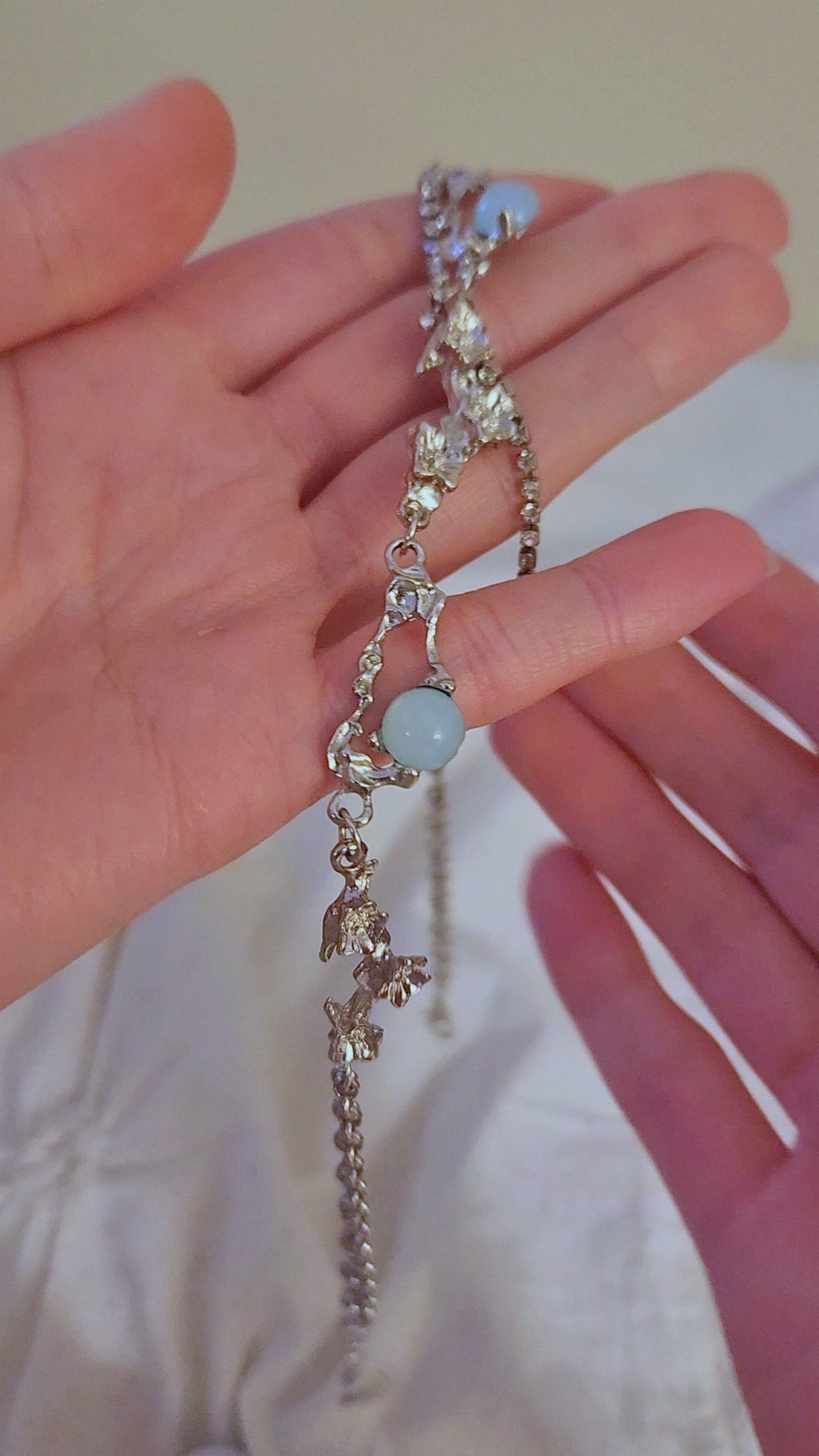 Video of ocean necklace being held and shown off in hands